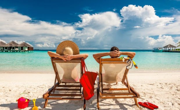 couple enjoying vacation and taking sun bath on beach side