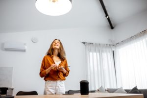 woman controlling light with a smart home automation systems